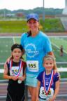 Amanda McVay, Meijer Vice President of Grocery, with children after Meijer LPGA Classic 5k Run & Walk presented by Kellogg’s