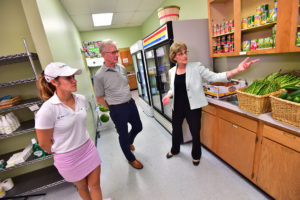 Executive Chairman Hank Meijer and LPGA Pro Brittany Benvenuto receiving a tour of a Simply Give food pantry partner