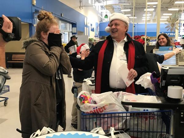 Meijer team member surprising customer by paying for her purchases during Very Merry Meijer event