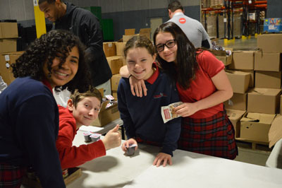 Students from St. Michael St. Gabriel Archangels School packing meals for Gleaners Food Bank