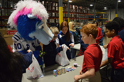 Indianapolis Colts mascot and students from St. Michael St. Gabriel Archangels School packing meals for Gleaners Food Bank