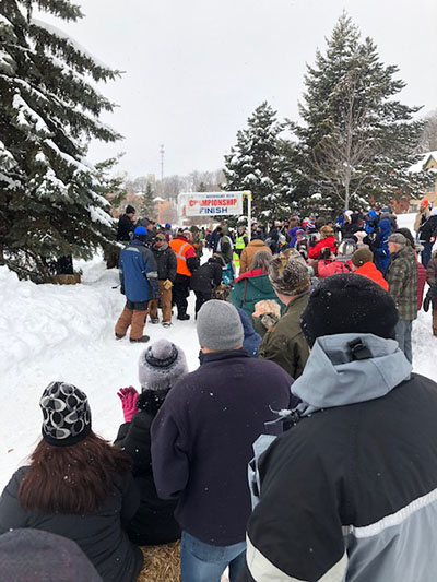 Crowds standing at the finish line during sled dog races sponsored by Meijer in Marquette, Mich.