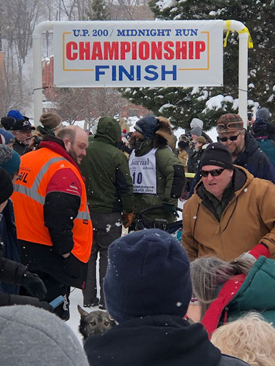 Participants and attendees at the finish line of sled dog races sponsored by Meijer in Marquette, Mich.