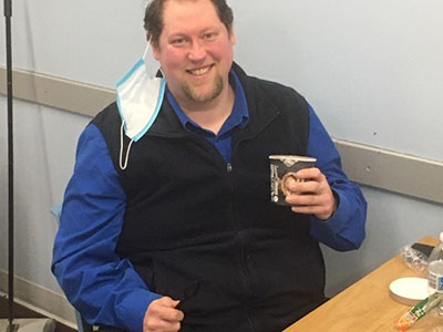 Meijer team member with ice cream pint donated by Hudsonville Ice Cream
