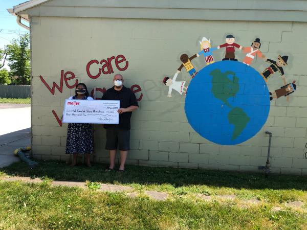 Lorain, Ohio Meijer Store Director Cassandra Robinson presenting $4,000 check donation to We Care We Share Ministries