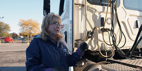 Debora Hass, Meijer truck driver supporting the Newport, Michigan distribution center, standing in front of truck