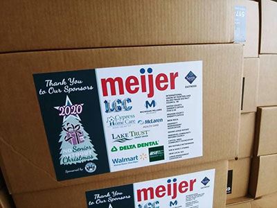 Stack of boxes full of household supplies and non-perishable food donations for 