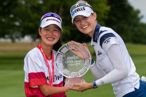 Nelly and Sophia with Trophy: Sophia and Nelly hold up Nelly’s Meijer LPGA Classic trophy together and smile.