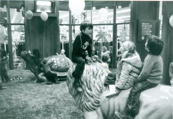 Children sitting on animal statues, surrounded by balloons at historic West Saginaw Meijer playland 