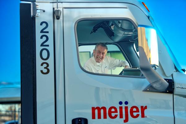 Meijer Fleet Driver Tom Meyer smiles through the window of his truck