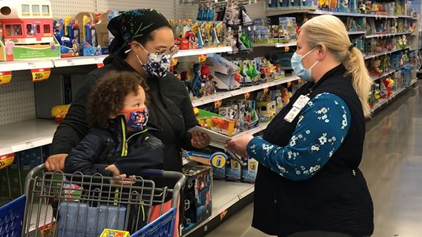 Aisha Greenlee-Wognum and son Milo are surprised with a $1,000 gift card by Meijer store director in the toy aisle of the Evergreen Park, Ill. store.