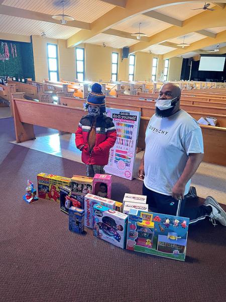 Milo Greenlee-Wognum presents toy donation to Kenyatta Smith, founder of Operation Cover Chicago, at Another Chance Church