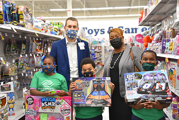Boys & Girls Club members hold up toys with Meijer Store Director Jarret Boyer and Toriah Monroe of the Boys & Girls Club of Greater Milwaukee