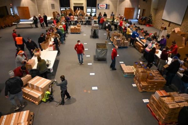 Volunteers organize food donations at the 2021 McHenry Knights of Columbus Holiday Food Drive sponsored by Meijer.
