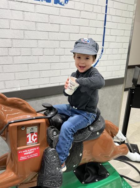 James Davies sits on Sandy the Pony in the Lorain, Ohio Meijer store holding a cup labeled “pennies for Sandy”