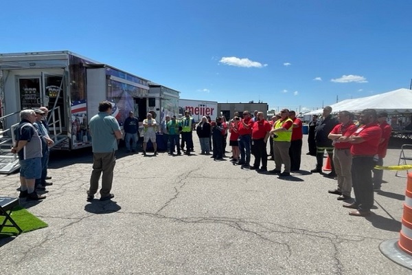 Meijer Team members watch Meijer fleet drivers be honored in front of the Wreaths Across America Mobile Education Exhibit at the Lansing distribution center.