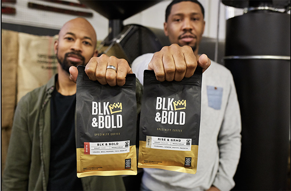 BLK & Bold team holding bags of coffee