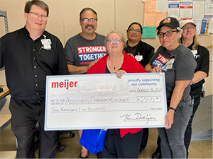 Meijer team members with check for $2,500 to Associated Charities of Lenawee County