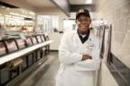 Meijer Butcher Tyrone Bray explaining his role preparing meat for customers in TV commercial
