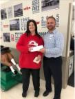 Meijer team member presenting Simply Give food pantry partner with an additional $5,000 