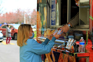 Employee at William Beaumont Hospital receiving free drinks and snacks from Meijer food truck
