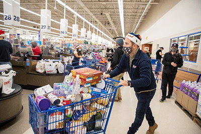 Detroit Red Wings volunteer shopping at Royal Oak store for Holiday Assist Donation with Red Wings, Detroit Tigers and Meijer
