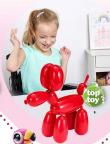 A catalog ad shows a blonde girl in a wheelchair grinning as she plays with a toy shaped like a balloon animal.