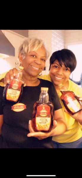 Michelle Foods co-founder, Michelle Hoskins, and her daughter holding bottles of syrup