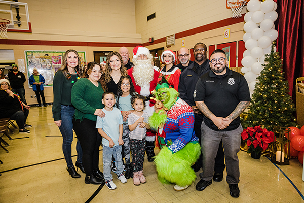 Allen-Field Students pose with Santa, Mrs. Claus, the Grinch and local Milwaukee celebrities at Holiday Magic Event