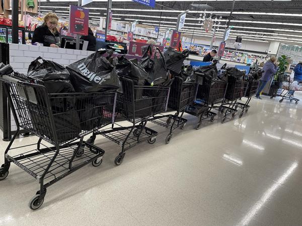 Seven Meijer carts filled with shopping bags to be donated to Cleveland families through the R.A.K.E. nonprofit.