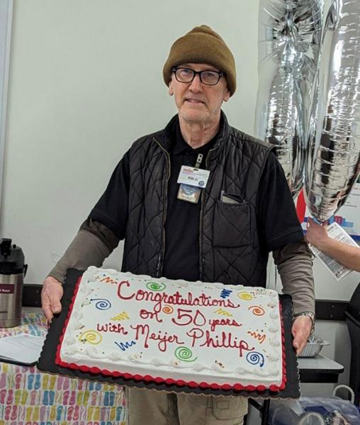Phil Davisson celebrates his 50th anniversary at Meijer in June with a cake and balloons.
