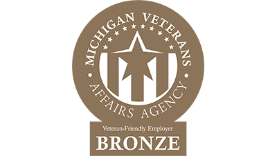A bronze logo with a star and stripes that reads “Michigan Veterans Affairs Agency Veteran Friendly Employer”