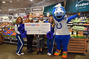 Colts cheerleaders and mascot with Meijer Store Director holding check to Riley Children’s Foundation in Meijer grocery area.